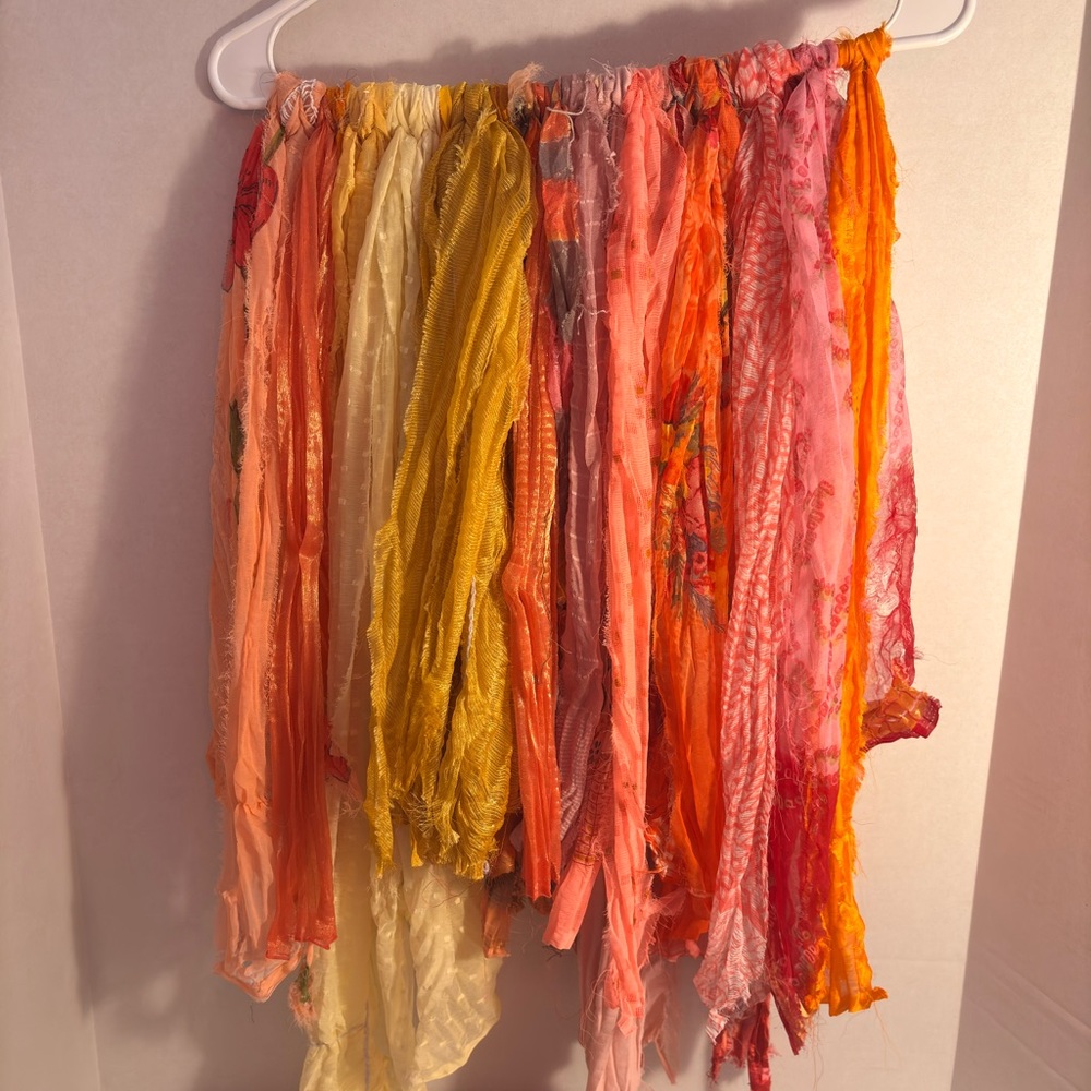 Vibrant Sari Silk fabric strips in orange and yellow hues. New.